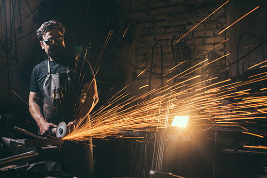 Worker with air grinder in his hands